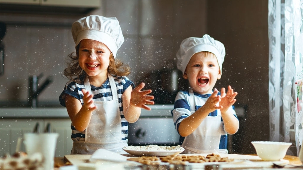 Happy family funny kids bake cookies in kitchen