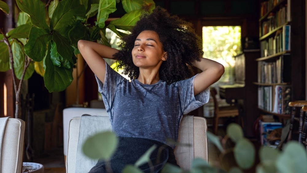 Young woman feels relaxed in beautiful home