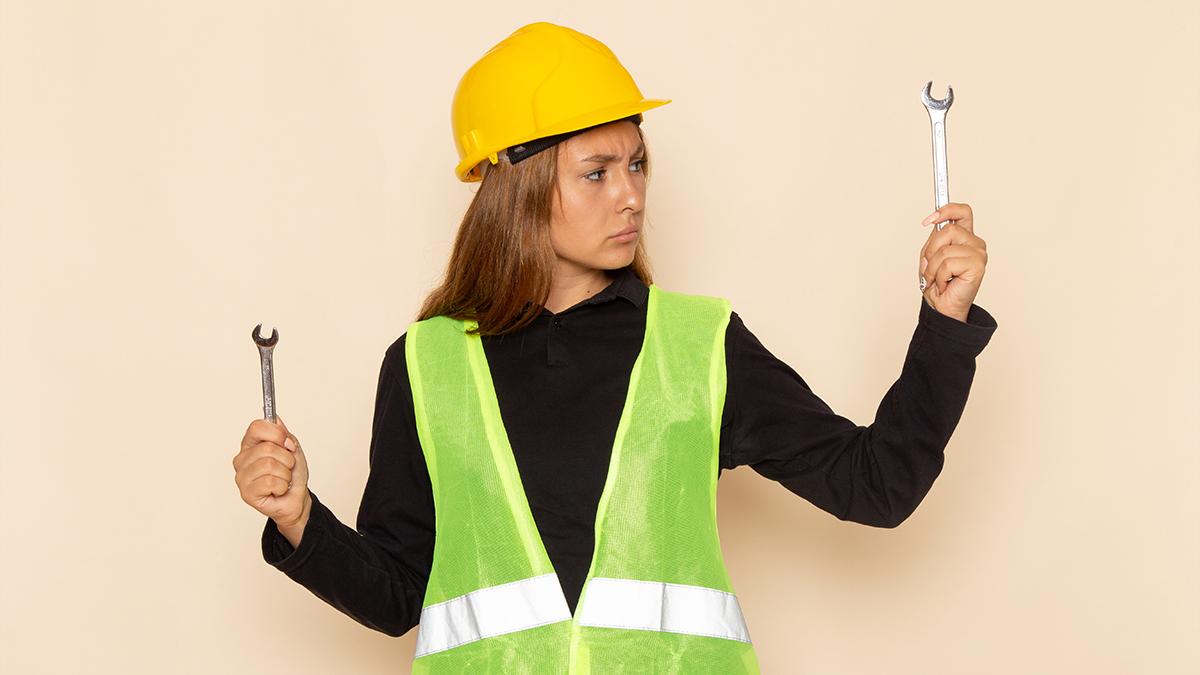 Front view of a female builder in yellow helmet