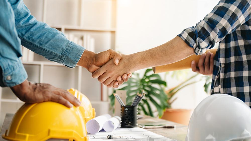 Engineers shaking hands together