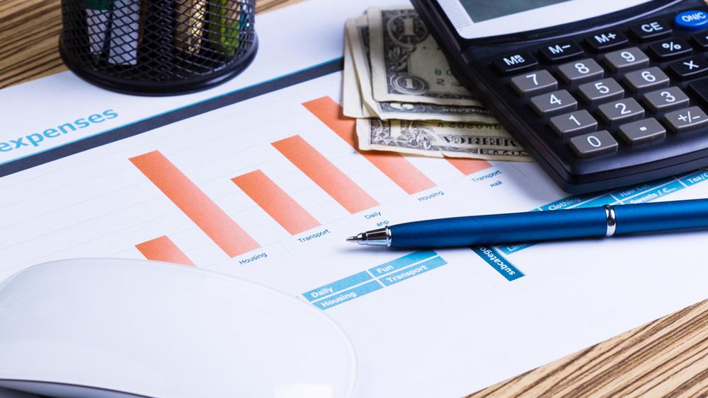 Graphs and calculator showing investment concept