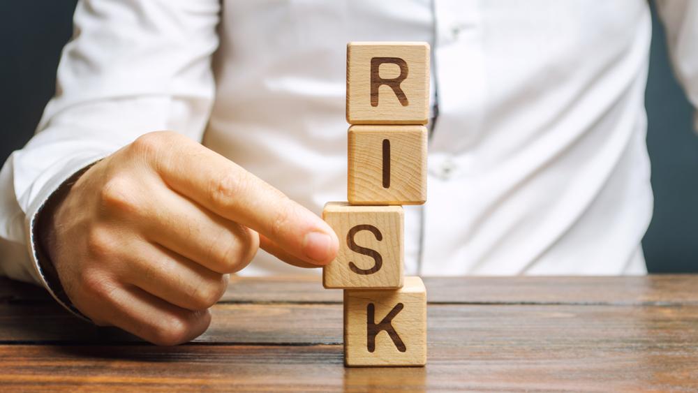 Man removes blocks with the word risk